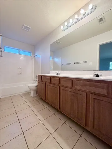 a kitchen with a sink a stove cabinets and utility room