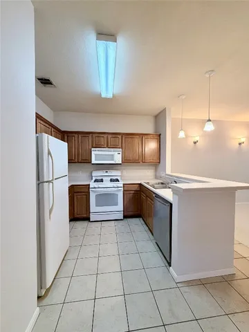 a large kitchen with cabinets and stainless steel appliances