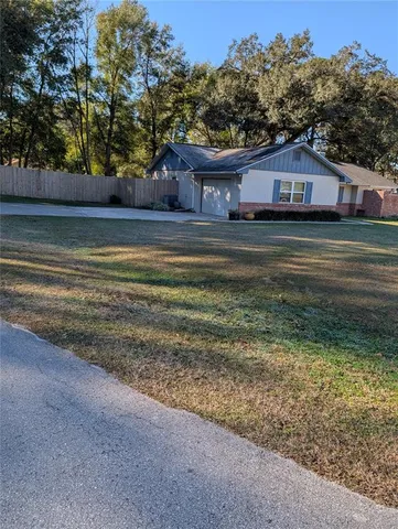 a house view with swimming pool in front of it