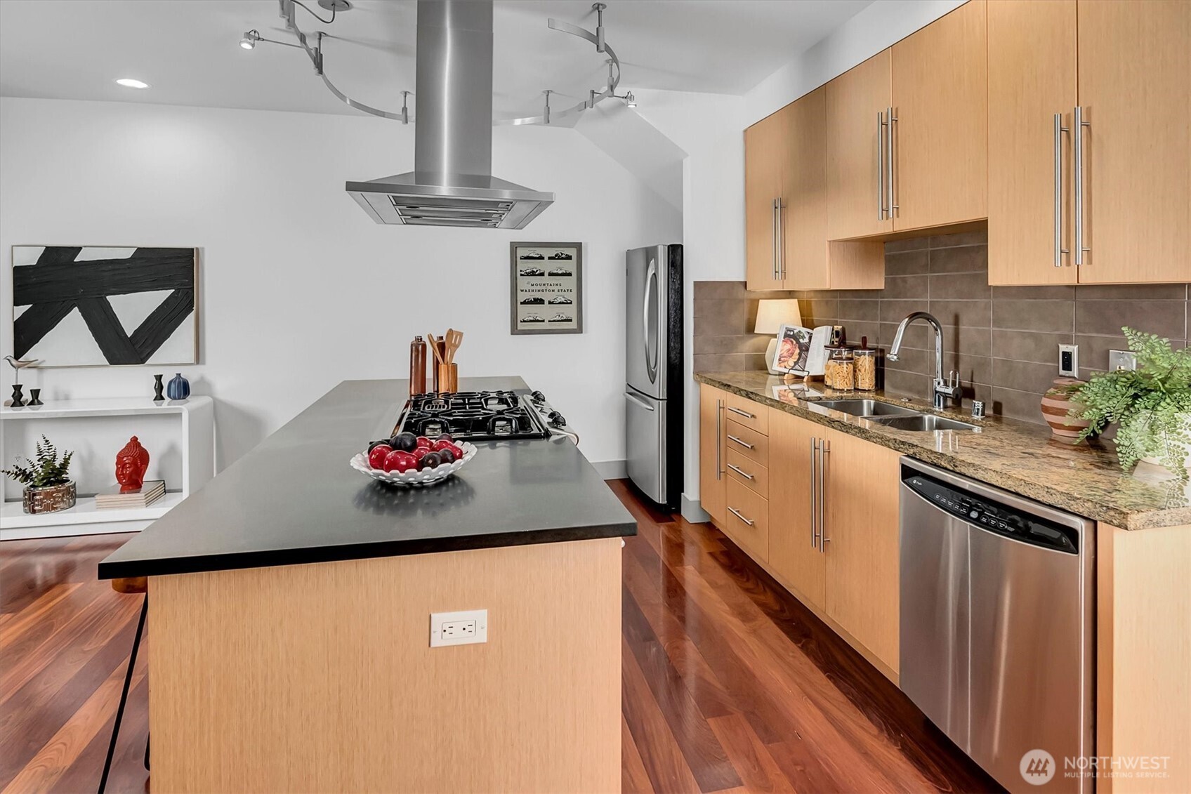 121 South Jackson Street, Unit 4 Seattle, WA 98104 - Photo 6 of 38 a kitchen with stainless steel appliances granite countertop a sink dishwasher and a refrigerator with wooden cabinets