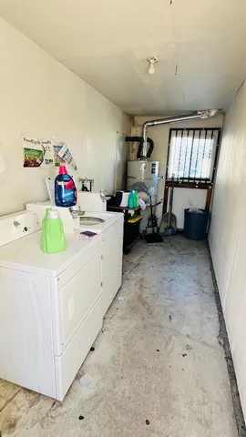 a utility room with cabinets dryer and washer