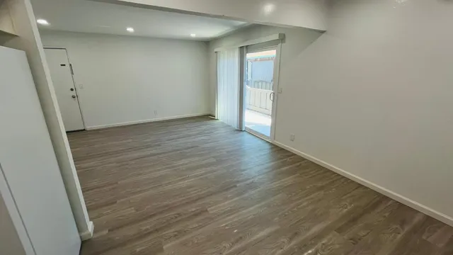a view of hallway with wooden floor