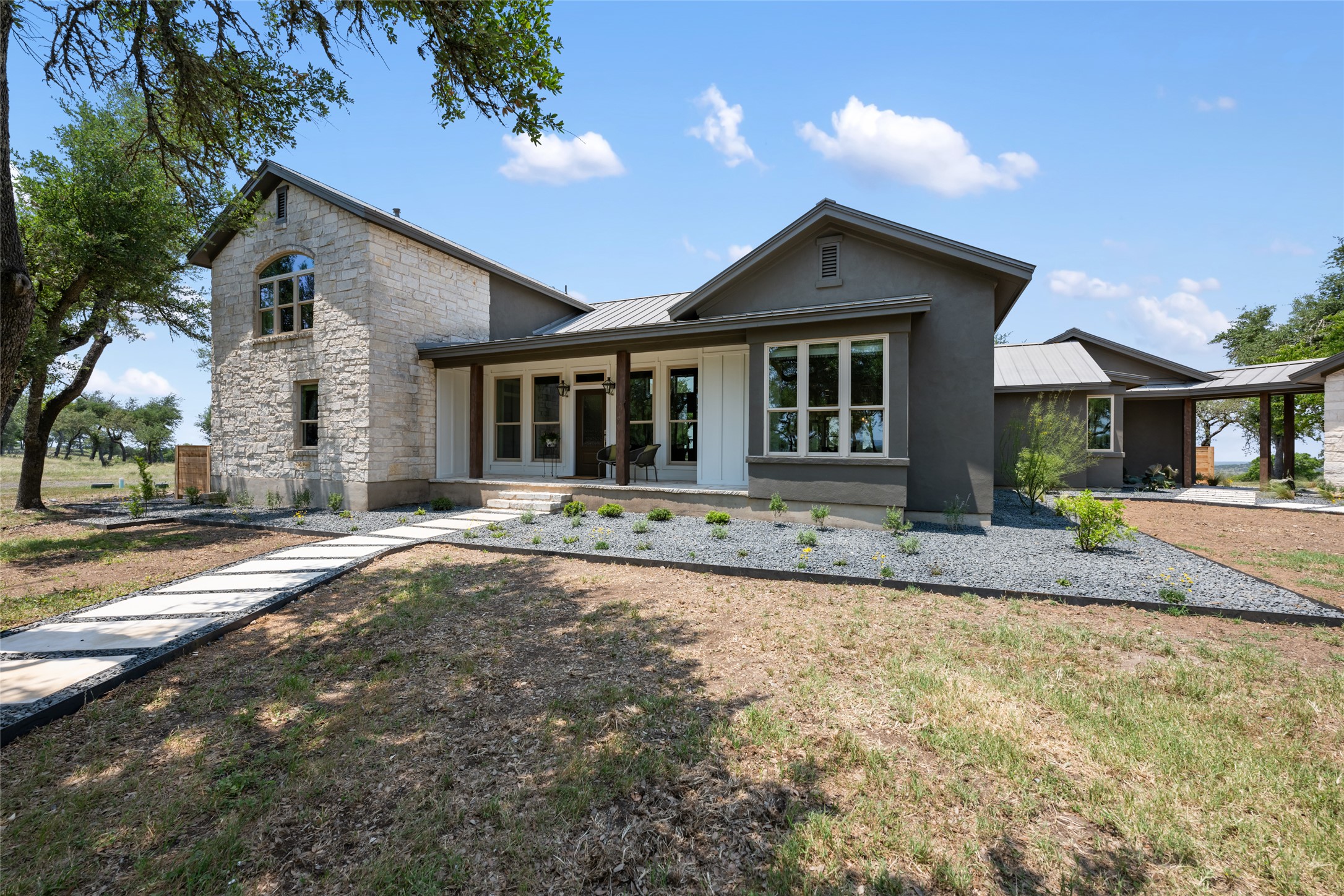 1276 Canyon Crossing View Dripping Springs, TX 78620 - Photo 2 of 33 a front view of a house with a yard and garage