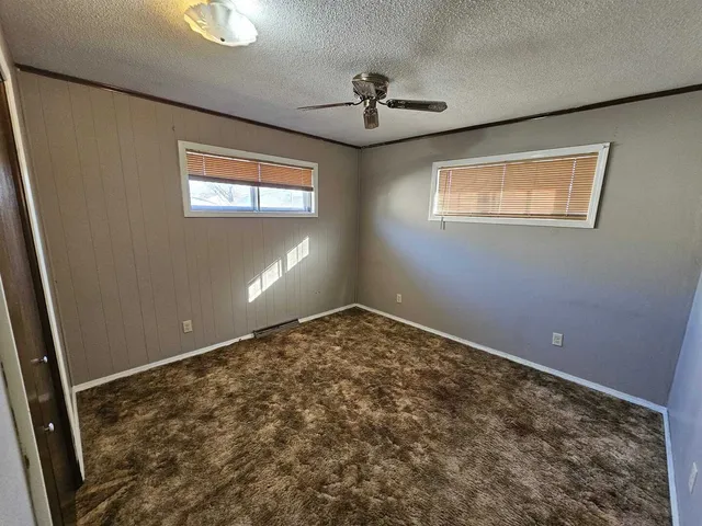 a view of a room with a ceiling fan
