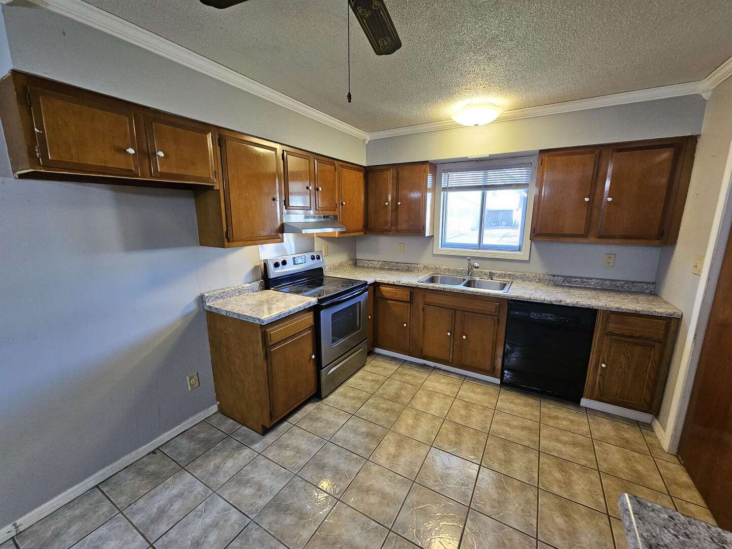 302 Marteeny Street Mount Vernon, IL 62864 - Photo 9 of 15 a kitchen with a sink a stove top oven a counter space and cabinets