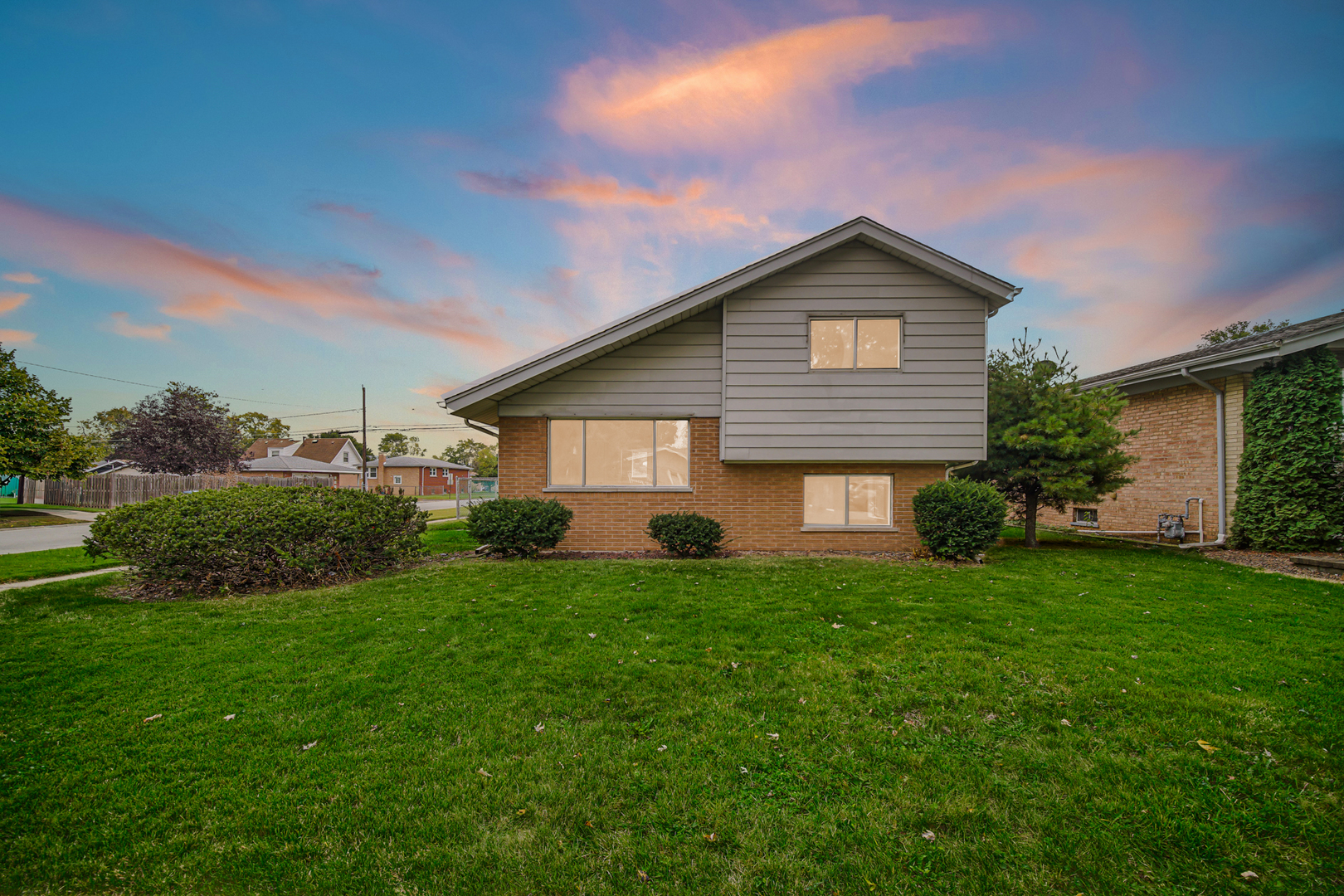14501 Tripp Avenue Midlothian, IL 60445 - Photo 1 of 19 a front view of a house with yard and green space