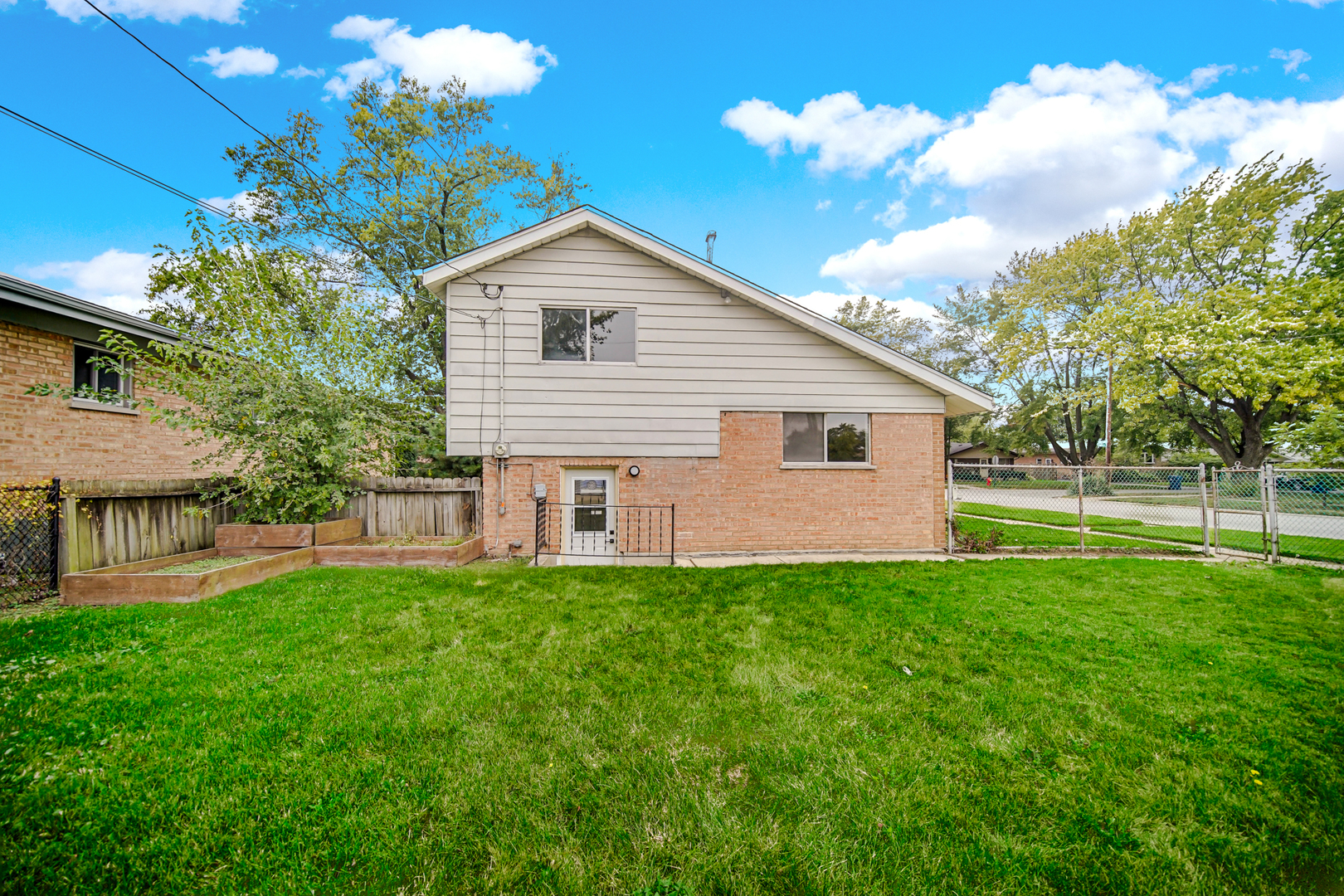 14501 Tripp Avenue Midlothian, IL 60445 - Photo 14 of 19 a front view of a house with a yard