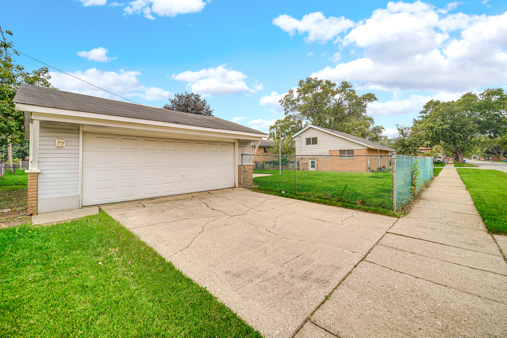 14501 Tripp Avenue Midlothian, IL 60445 - Photo 17 of 19 a front view of a house with a yard and garage