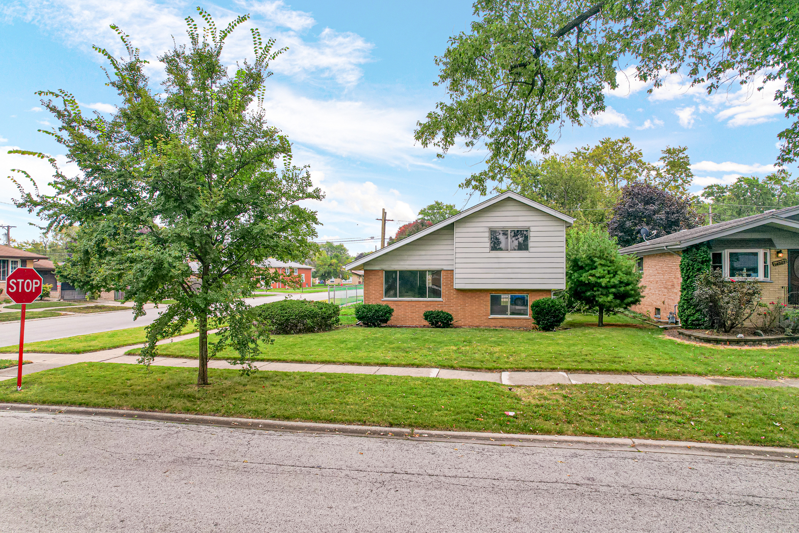 14501 Tripp Avenue Midlothian, IL 60445 - Photo 3 of 19 a front view of a house with a yard