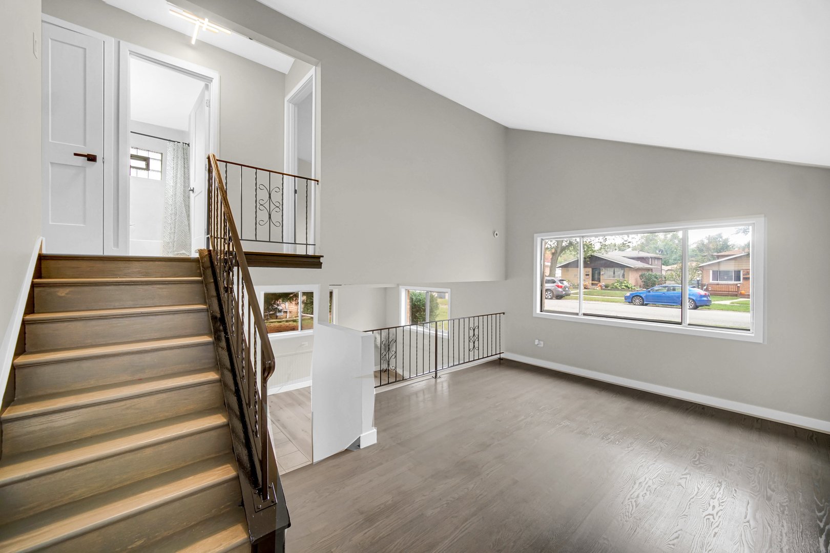 14501 Tripp Avenue Midlothian, IL 60445 - Photo 4 of 19 a view of an empty room with wooden floor and stairs