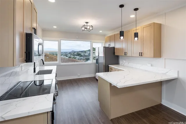 a kitchen with a sink a counter space and a refrigerator