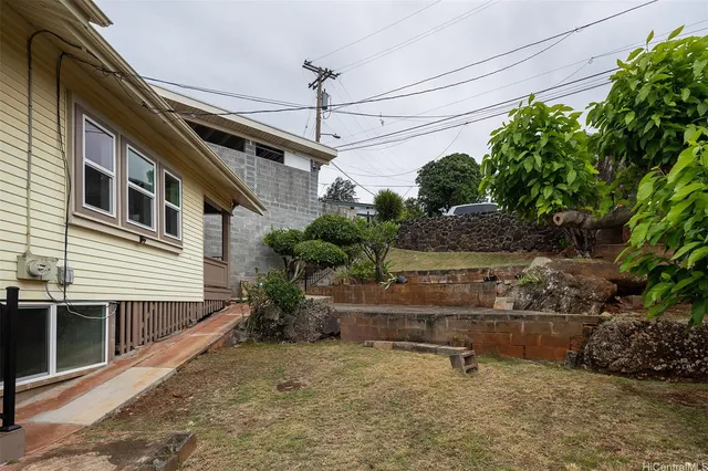 a backyard of a house with plants and outdoor seating