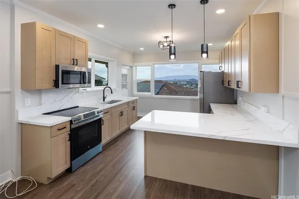 a large kitchen with granite countertop a stove and a sink