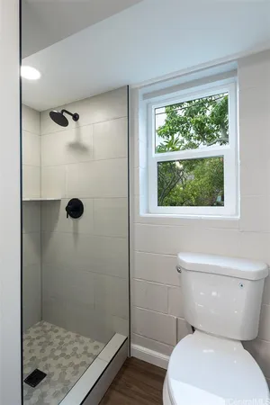 a bathroom with a toilet and a shower