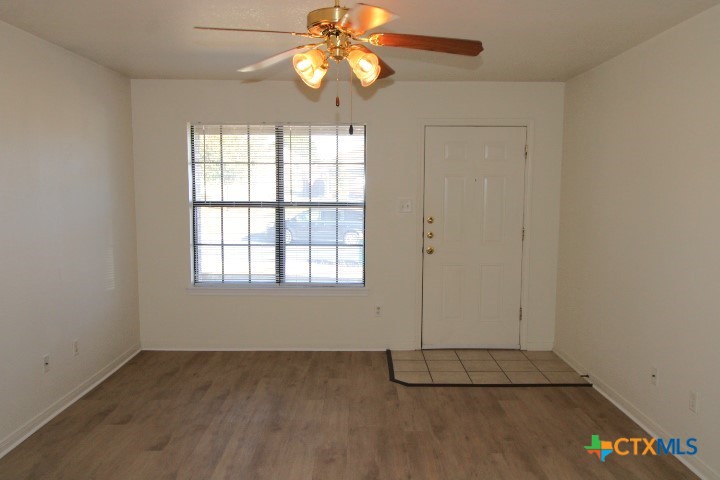 305 Cedar Ridge Drive, Unit B Nolanville, TX 76559 - Photo 2 of 14 an empty room with windows and fan