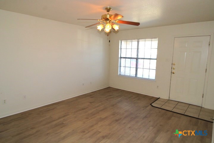 305 Cedar Ridge Drive, Unit B Nolanville, TX 76559 - Photo 3 of 14 a view of an empty room with a window