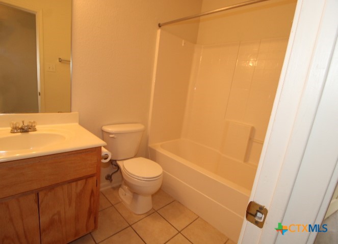 305 Cedar Ridge Drive, Unit B Nolanville, TX 76559 - Photo 10 of 14 a bathroom with a sink a toilet and shower