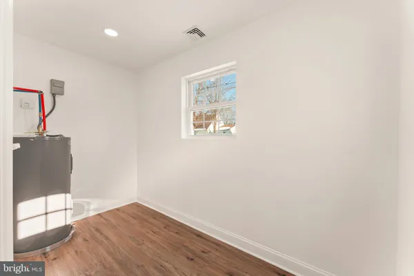 a view of a hallway with wooden floor and entryway