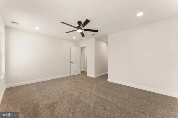 a view of a hallway with wooden shelves