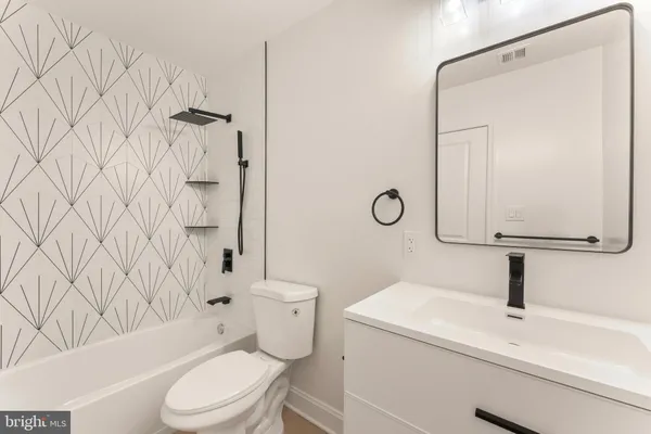 a bathroom with a toilet sink and shower