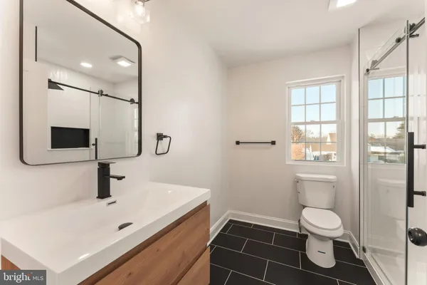 a bathroom with a shower and a sink