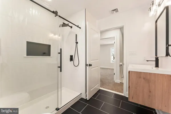 a bathroom with a shower a toilet and a shower
