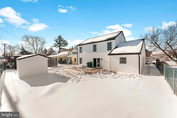 a view of a white house with a yard