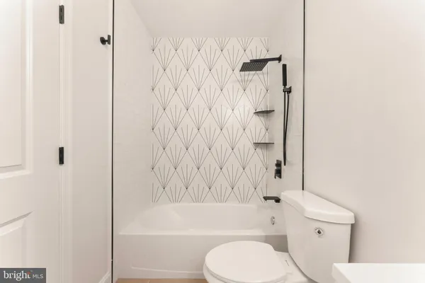 a bathroom with a toilet and shower