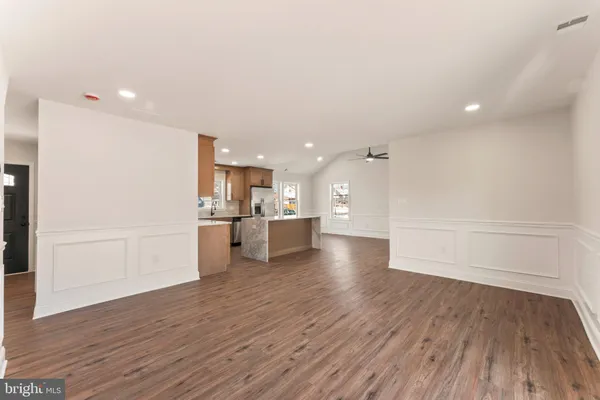 a view of a kitchen with a sink and a refrigerator