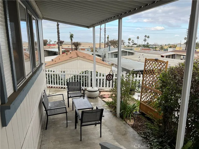 a roof deck with table and chairs and wooden floor