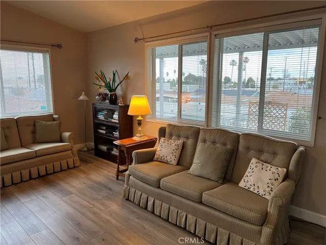 a living room with furniture and a kitchen view