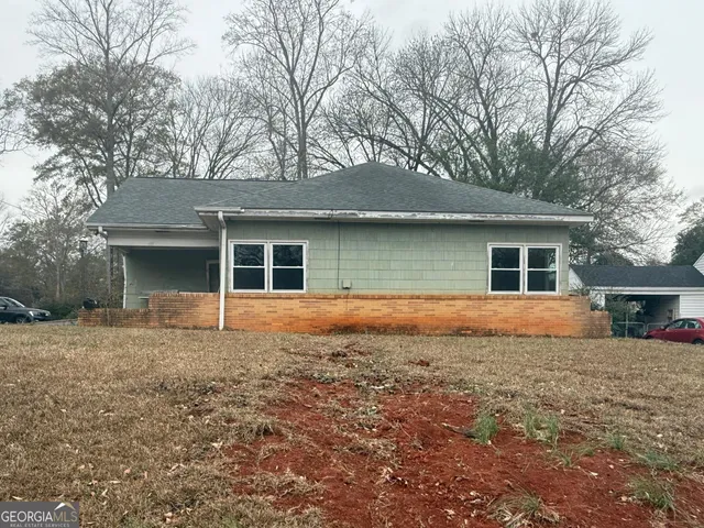 a house that has a tree in front of it