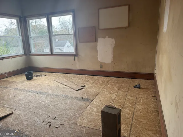 a view of a livingroom with wooden floor and a window