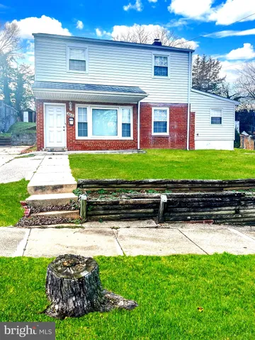 a front view of a house with a yard and outdoor seating