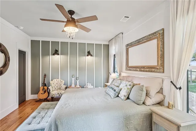 a bedroom with a large bed and a large window