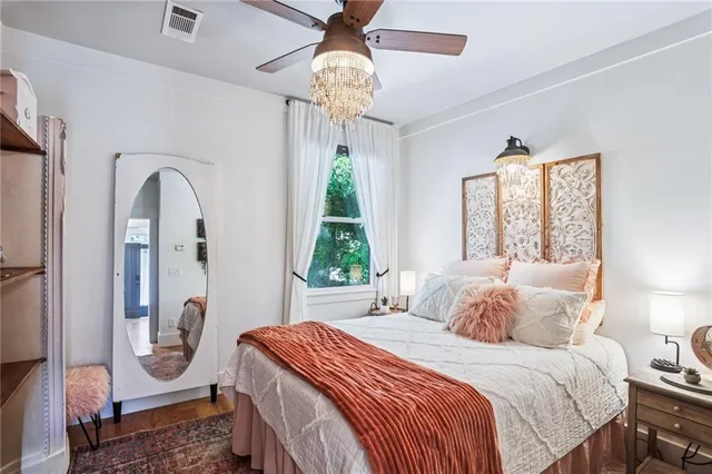 a bedroom with a bed and a chandelier