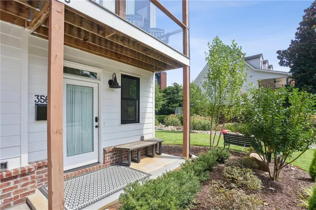 a view of house with backyard and sitting area