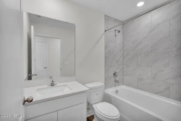a bathroom with a sink toilet a bathtub and a vanity