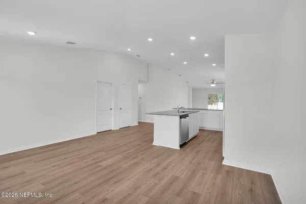 a view of kitchen with a sink cabinets and a window