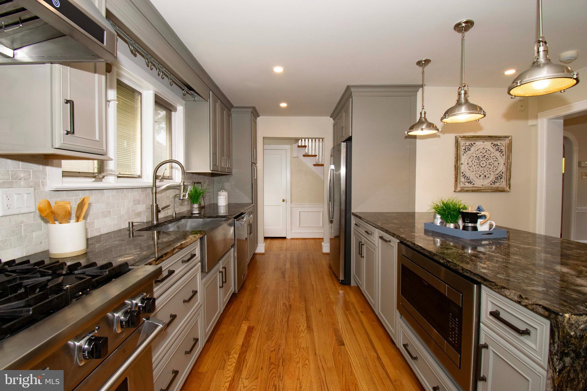 501 East Manoa Road Havertown, PA 19083 - Photo 19 of 42 a large kitchen with stainless steel appliances granite countertop a stove a sink dishwasher and a wooden cabinets