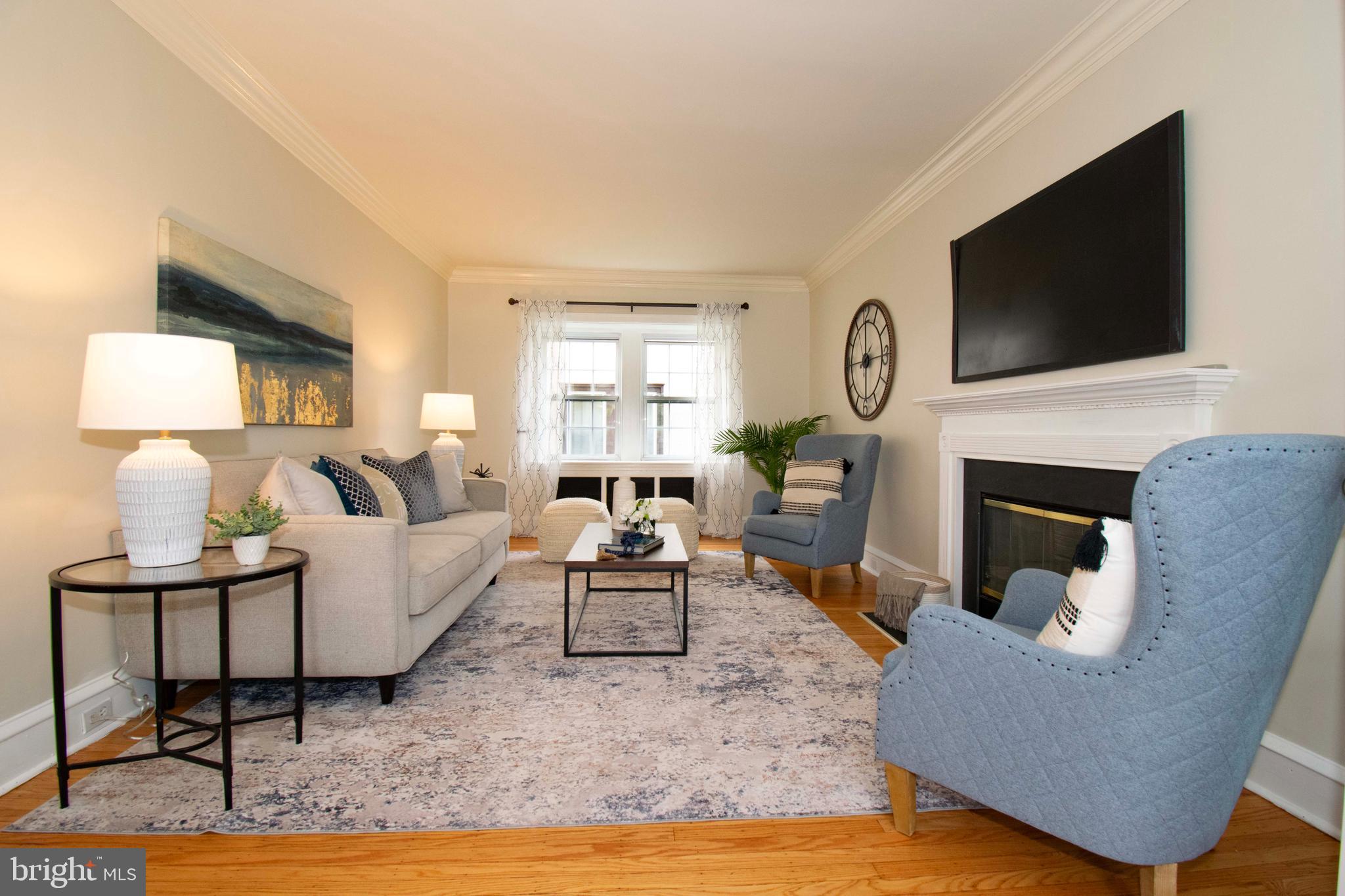 501 East Manoa Road Havertown, PA 19083 - Photo 8 of 42 a living room with furniture a flat screen tv and a fireplace
