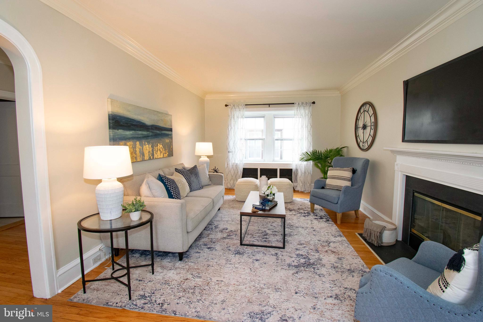 501 East Manoa Road Havertown, PA 19083 - Photo 9 of 42 a living room with furniture a fireplace and a flat screen tv