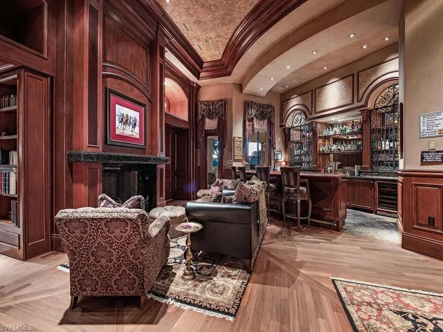 a living room with fireplace furniture and a rug