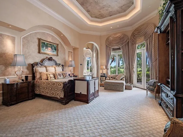 a bedroom with furniture and a flat screen tv