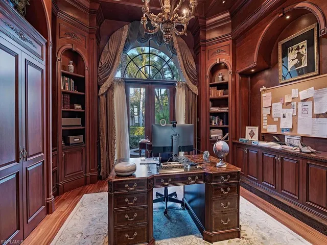 a view of a dining room with furniture and chandelier