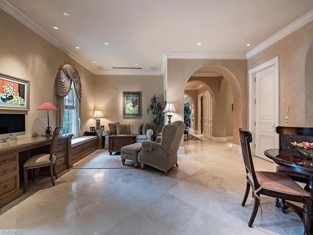 a living room with furniture and a piano