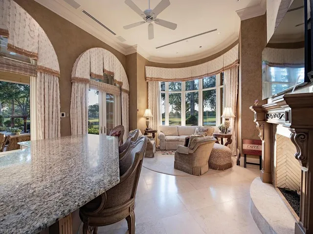 a dining room with furniture a chandelier and wooden floor