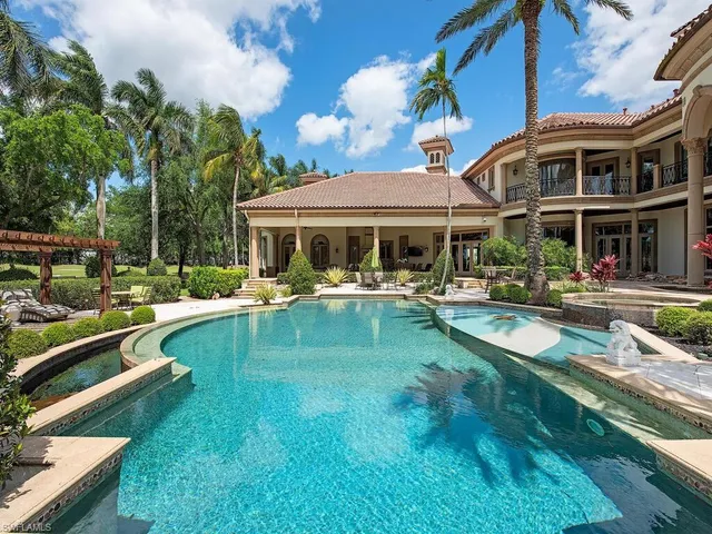a view of a patio with couches and a table and chairs under an umbrella