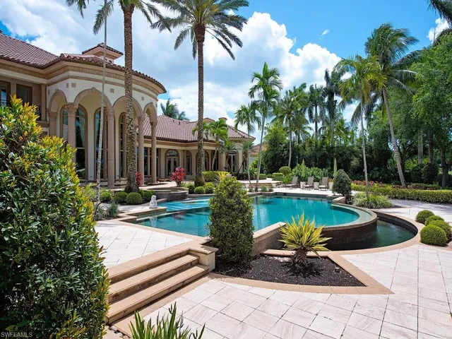 a view of a house with swimming pool and sitting area