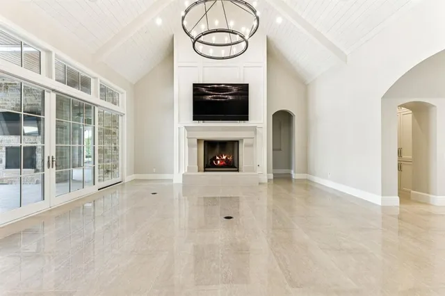 a view of an empty room with furniture and fireplace